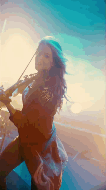 a woman is playing a violin in a dark room