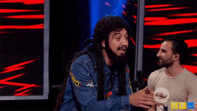 a man with dreadlocks and a t-shirt that says riel on it