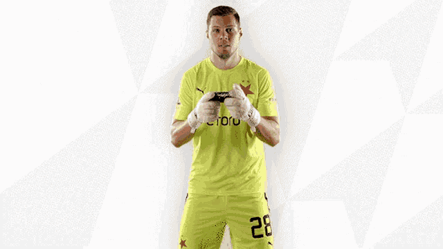 a soccer player wearing a yellow etoro jersey