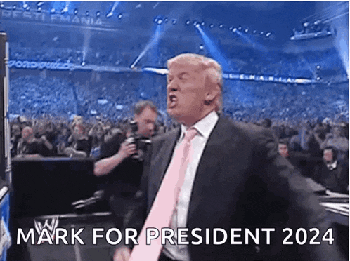 a man in a suit and pink tie is screaming in front of a crowd and says mark for president 2024