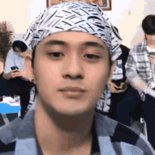 a man wearing a headband is making a funny face .