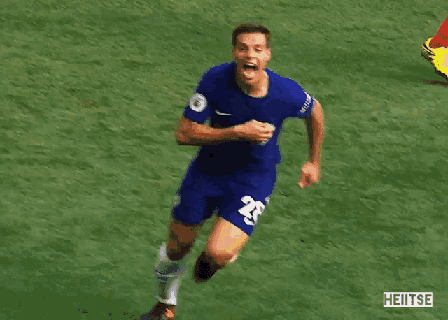 a soccer player with the number 28 on his shirt is running on the field