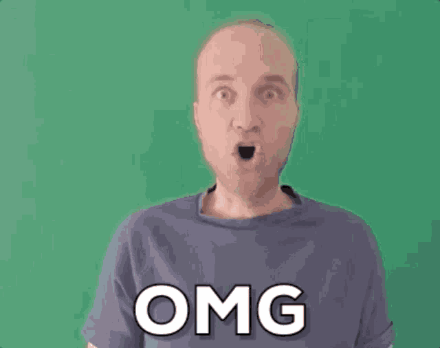 a man in a purple shirt is making a funny face and the word omg is on his shirt .