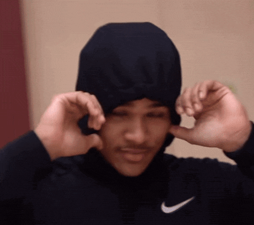 a man wearing a black nike sweatshirt and a black hoodie