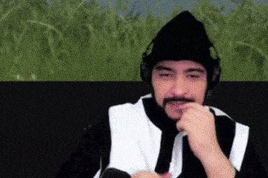 a man with a beard wearing headphones and a black beanie