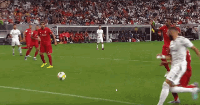a soccer player with the number 32 on his back kicks a ball