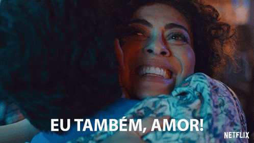 a woman is hugging another woman with the words eu também amor written below her