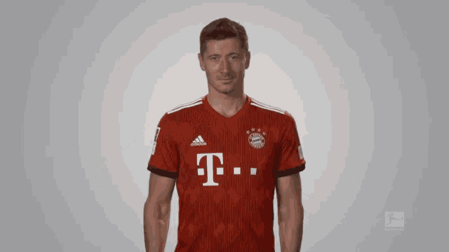 a man in a red t-mobile shirt stands in front of a grey background