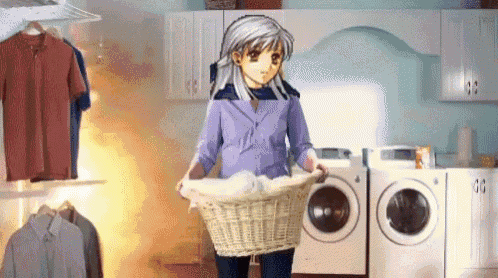 a woman is holding a laundry basket in a laundromat .