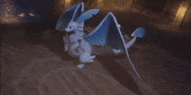 a statue of a dragon with its wings spread in the dark