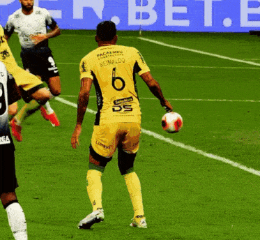 a soccer player in a yellow jersey with the number 6 on it