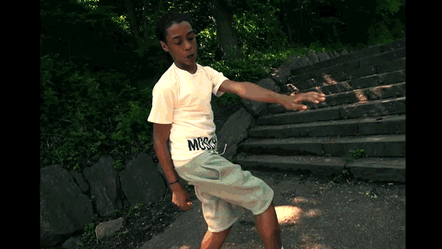 a boy wearing a white shirt that says moss