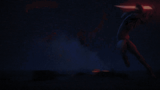 a person in a dark room with a red light coming out of their head