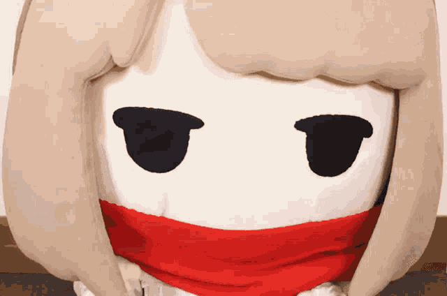 a stuffed toy with a red scarf around its neck