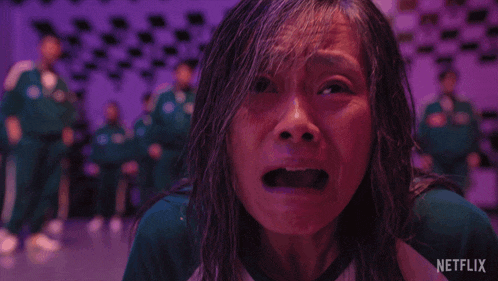 a woman is crying in front of a purple background with a netflix logo in the corner