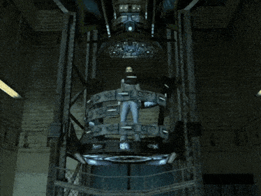 a video game shows a man standing in a machine with a light coming from it
