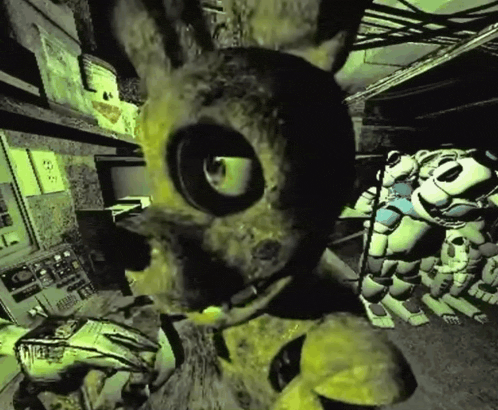 a yellow rabbit with a large eye is standing in a dark room with other stuffed animals