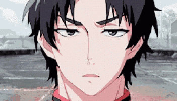 a close up of a boy 's face with a serious look on his face .