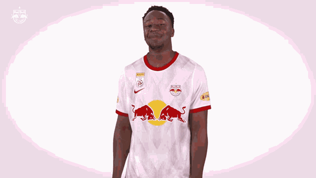 a man in a red bull shirt is dancing