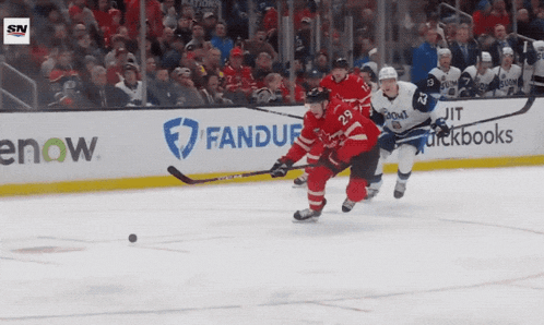 a hockey game is being played in front of a banner that says fandue