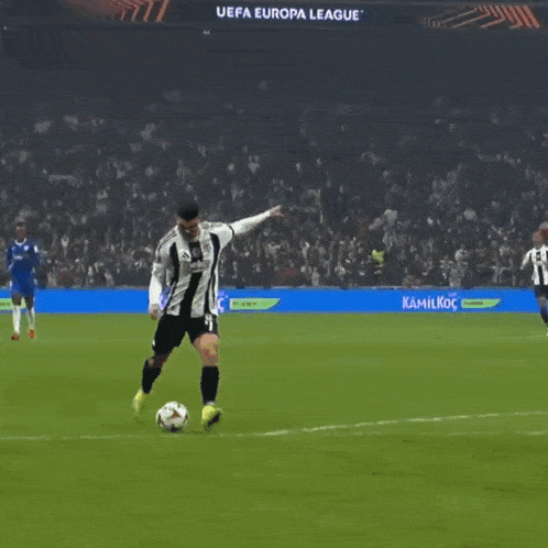 a soccer game is being played in a stadium with a banner that says uefa champions league on it
