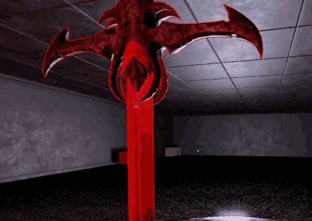 a red statue in a dark room with a white light shining on it