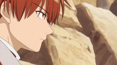 a close up of a person 's face with red hair and a white shirt