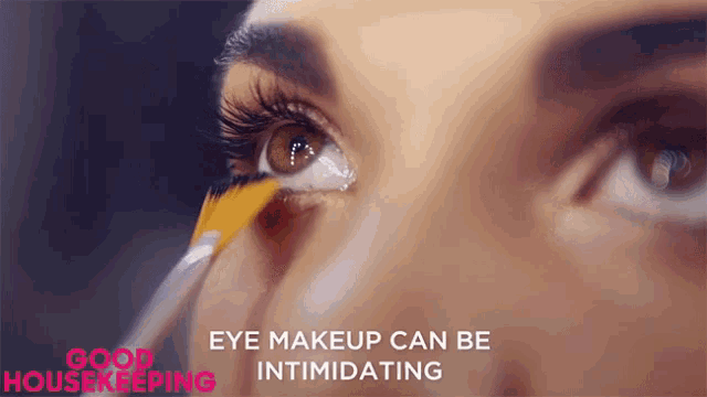 a woman is applying eye makeup with the words eye makeup can be intimidating below her