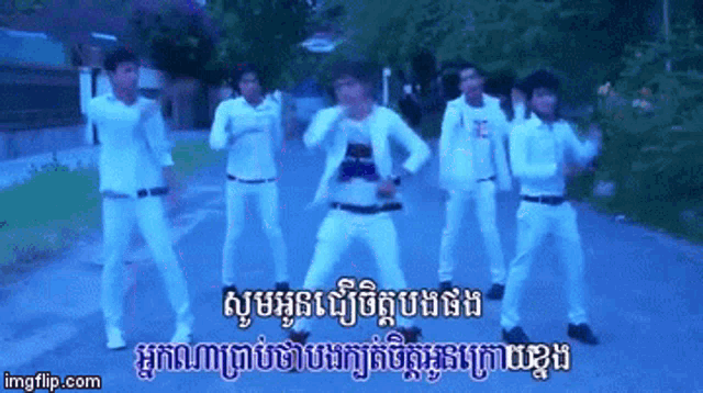a group of men are dancing on a street with a watermark that says imgflip.com on it