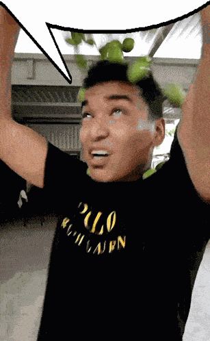 a man wearing a black polo ralph lauren t-shirt holds up his arms
