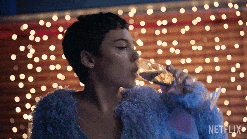 a woman drinking from a glass with netflix written on the bottom right