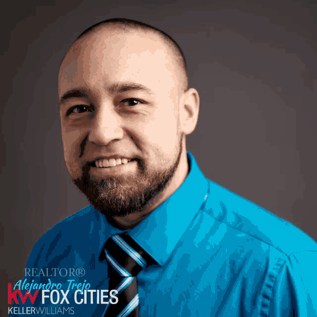 a man with a beard is wearing a blue shirt and tie and is a realtor for keller williams