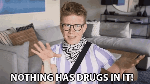 a man wearing glasses and a striped shirt says " nothing has drugs in it "