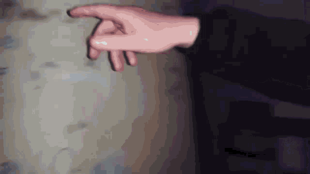 a close up of a person 's hand pointing