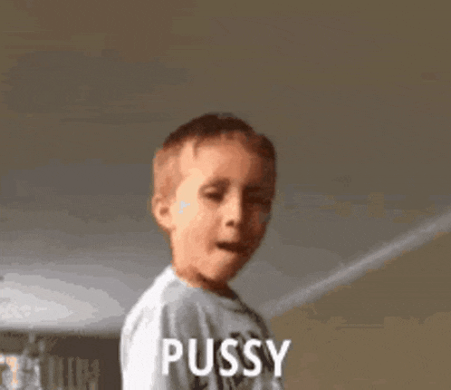 a young boy in a white shirt is making a funny face and saying pussy .
