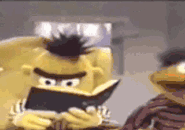bert from sesame street is reading a book to elmo .