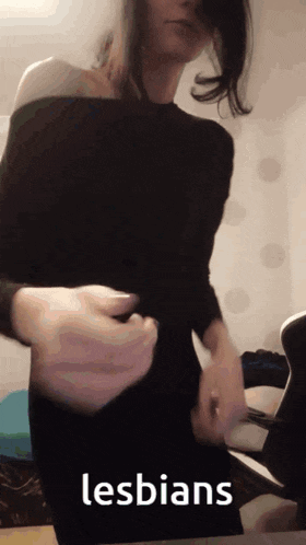 a woman in a black dress is dancing with the word lesbians in the background