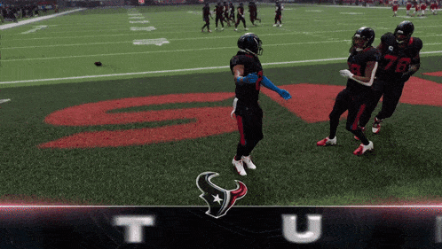 a group of football players are standing on a field with the letter t on the bottom