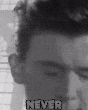 a man 's face is shown in a black and white photo with the word never below it
