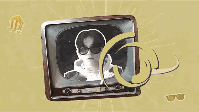 a picture of a man wearing sunglasses is on a tv screen with a popcorn box in the background