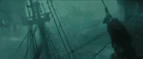 a giant squid is holding a book in its mouth .