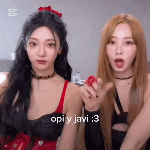 two girls are standing next to each other and one of them is wearing a choker