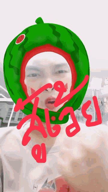 a person wearing a watermelon hat with the word ' a ' written in red