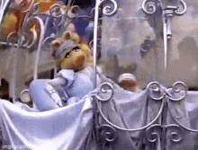 miss piggy from the muppets is sitting in a stroller