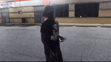 a man wearing a black shirt that says ' r & r ' on it