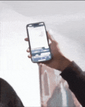 a person holding a cell phone in their hand