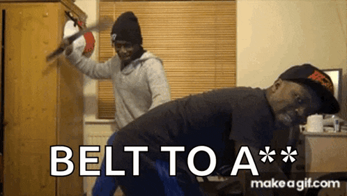 a man is being spanked by another man with the words belt to a ** make a gif.com below him