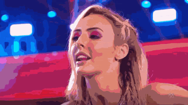 a pixelated image of a woman with a wrestling logo on the bottom left
