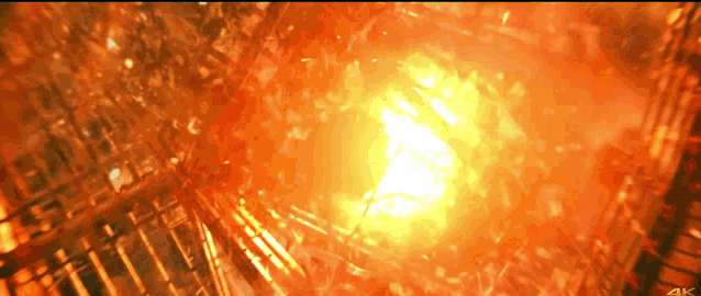 a 4k screen shows a bright orange light coming out of a building