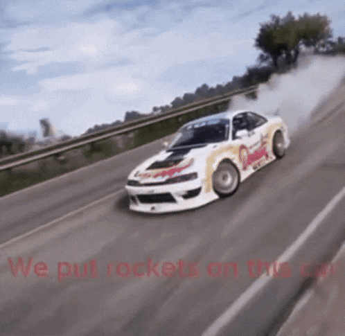 a car is driving down a road with the words we put rockets on this car written on the bottom